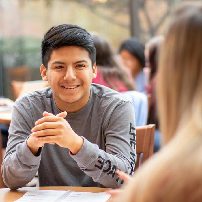 Students talking at table in coffee shop